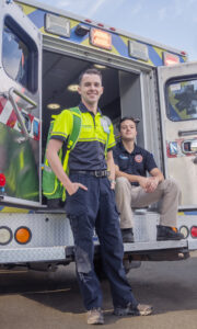 Bergen Hall and Brandon Bacon at the back of an open EMS vehicle