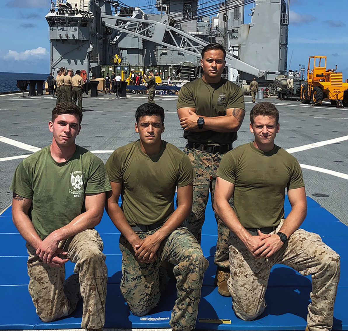 Sergeant Christopher Leon (standing) on the 31st Expeditionary Unit, pictured with Lance Corporal Hyde, Lance Corporal Castellanos, and Lance Corporal Peterson