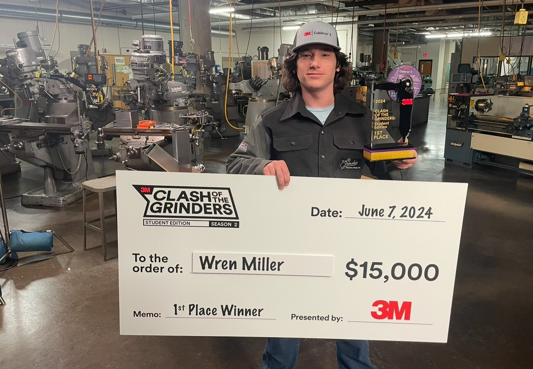 Wren holding a check